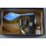 A BOX OF DISTRESSED SILVER, to include enamelled hairbrush, two brushes, etc