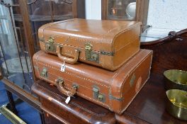 A SET OF TWO GRADUATING TAN LEATHER SUITCASES, Cornell label attached A.W.E. Stamped to each