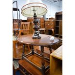 AN OAK DROP LEAF OCCASIONAL TABLE, a folding three tier cake stand and a ceramic table lamp (3)