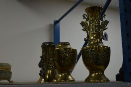 A PAIR OF CHINESE BRASS TWIN HANDLED VASES, cast with prunus blossom and birds, height 30cm, one a.f