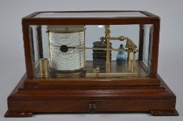 A BAROGRAPH IN A GLAZED WOODEN CASE, no makers markings, with a quantity of spare recording charts