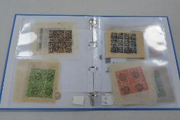 FORTY SHEETS OF TIBET STAMPS, in a binder