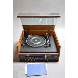 A VINTAGE DYNATRON SRX 26 RADIOGRAM, with a teak exterior and smoked perspex lid, fitted with a