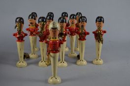 THIRTEEN TURNED WOODEN MILITARY BAND FIGURES, twelve musicians and drum major, hand painted with