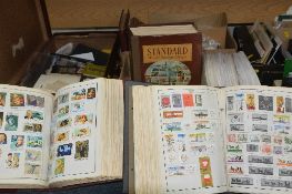 AN ACCUMULATION OF STAMPS AND COVERS, in albums (including three large printed Harris albums) and