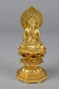 A MODERN GILT METAL SEATED BUDDHA, pierced oval head rest, seated cross legged on a multi tier