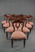 A SET OF TEN VICTORIAN MAHOGANY DINING CHAIRS, crown backs, stuffed over serpentine seats, on turned