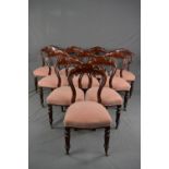 A SET OF TEN VICTORIAN MAHOGANY DINING CHAIRS, crown backs, stuffed over serpentine seats, on turned