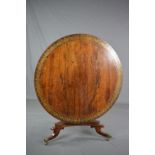 A REGENCY ROSEWOOD AND BRASS INLAID TILT TOP CENTRE TABLE, the circular top with a wide band of