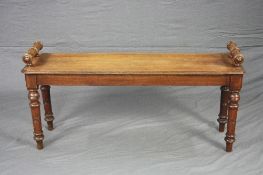 A VICTORIAN MAHOGANY RECTANGULAR WINDOW SEAT, with canted corners, raised cylindrical seat ends,