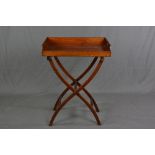 A LATE VICTORIAN MAHOGANY BUTLERS TRAY ON FOLDING STAND, the rectangular tray with cut away handles,