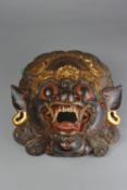AN ORIENTAL CARVED WOODEN DRAGON MASK, painted decoration, pierced holes for hanging, losses to