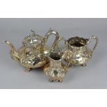 AN EARLY VICTORIAN THREE PIECE SILVER TEA SERVICE, of ogee form, Rococo Revival foliate repousse