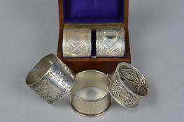A VICTORIAN WALNUT AND MAHOGANY CASED PAIR OF CIRCULAR SILVER NAPKIN RINGS, foliate engraved