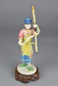 A LATE 19TH CENTURY JAPANESE IVORY OKIMONO, of a male figure holding a ceremonial staff, painted/