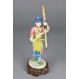 A LATE 19TH CENTURY JAPANESE IVORY OKIMONO, of a male figure holding a ceremonial staff, painted/