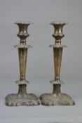 A PAIR OF EDWARDIAN SILVER CANDLESTICKS, foliate cast decoration to removable sconce, shoulders