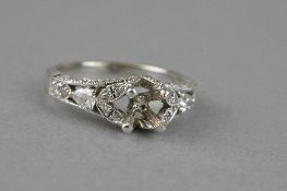 A MODERN DIAMOND RING MOUNT, fancy design pave set to the sides, shoulders and under bezel, two pear
