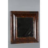 A WILLIAM & MARY WALNUT OYSTER VENEER CUSHION FRAMED MIRROR, later bevel edged plate, plate size