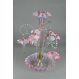 A PINK VASELINE GLASS EPERGNE, central trumpet shaped vase surrounded by a further three vases and