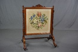 A VICTORIAN ROSEWOOD FIRESCREEN, carved top rail above a rectangular glazed panel containing a