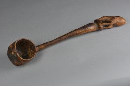 A CARVED TREEN LADLE, with Kiwi bird finial, the ladle bowl exterior carved as a head, length
