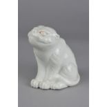 A JAPANESE HIRADO STYLE WHITE GLAZED PORCELAIN MODEL OF A SEATED TIGER, height approximately 15cm