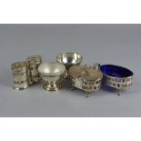 A GEORGE V ADAM STYLE FOUR PIECE SILVER CRUET SET, of oval form, comprising a pair of pepperettes, a
