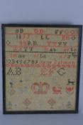 A 19TH CENTURY NEEDLEWORK SAMPLER, cotton on a coarse linen ground, with alphabets, numbers,