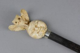 A 19TH CENTURY EBONISED WALKING CANE, carved ivory finial in the form of an owl standing with open