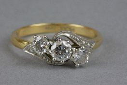A MID LATE 20TH CENTURY THREE STONE DIAMOND CROSSOVER RING, estimated total round brilliant cut