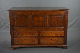 A GEORGE III OAK LANCASHIRE MULE CHEST, the plank top above a triple panel front and four short