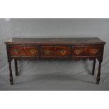 A GEORGE III OAK DRESSER, fitted with three deep drawers above a wavy apron, on front baluster