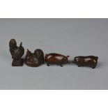 A CARVED WOODEN NETSUKE IN THE FORM OF A SEATED COCKEREL, height approximately 4cm x length 4.5cm,