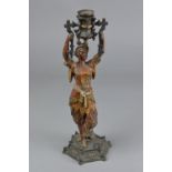 A LATE 19TH CENTURY CAST IRON FIGURAL CANDLESTICK, modelled as a Siamese dancer holder aloft a