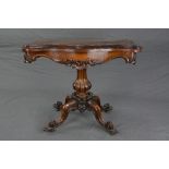 AN EARLY VICTORIAN ROSEWOOD FOLD OVER CARD TABLE, of serpentine outline, the interior with circle of