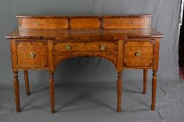 AN EARLY 19TH CENTURY OAK AND MAHOGANY CROSSBANDED BREAKFRONT SIDEBOARD, the short raised back