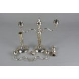 A PAIR OF ELIZABETH II SILVER THREE BRANCH CANDELABRA, one defective, the cylindrical column with