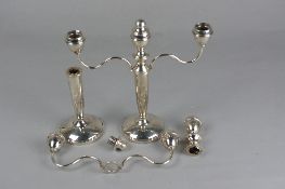 A PAIR OF ELIZABETH II SILVER THREE BRANCH CANDELABRA, one defective, the cylindrical column with