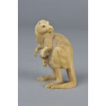 A LATE 19TH CENTURY CARVED IVORY FIGURE OF A KANGAROO, with joey in its pouch, lacks ears, bears