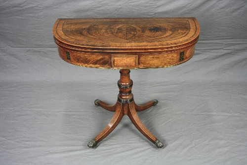 A GEORGE III MAHOGANY 'D' SHAPED FOLD OVER TEA TABLE, crossbanded and with line inlay, the frieze