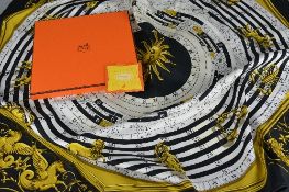 A HERMES ASTROLOGIE PATTERN SILK SCARF, black, cream and yellow, titled Dies Et Hores to centre,