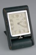 A 1930'S JAEGER LE COULTRE TRAVEL ALARM CLOCK, in green leather case