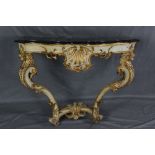 A 19TH CENTURY BAROQUE STYLE GESSO AND GILTWOOD CONSOLE TABLE, the later ebonised faux black