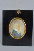 AN EARLY 19TH CENTURY PORTRAIT MINIATURE OF A GENTLEMAN, seated in profile, wearing a blue
