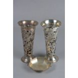 A PAIR OF EDWARDIAN SILVER VASE SLEEVES, of conical form, wavy rims above pierced and chased