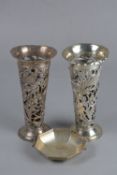 A PAIR OF EDWARDIAN SILVER VASE SLEEVES, of conical form, wavy rims above pierced and chased