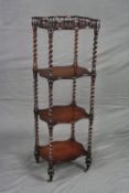 A MID VICTORIAN ROSEWOOD FOUR TIER WHAT-NOT, of wavy rectangular form, the top tier with spindle
