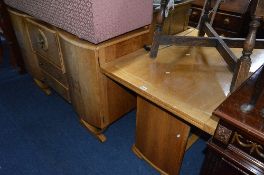 AN ART DECO WALNUT DRAW LEAF TABLE, a cocktail sideboard with fall front centre above two drawers,