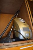 A MEILE S4 GOLD EDITION VACUUM CLEANER and an oak corner tv stand (2)